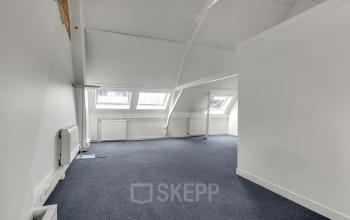 Spacious office interior at Stadsring 248-250 in Amersfoort Centrum with sloped ceilings and large windows providing ample natural light, ideal for office space rental.