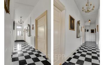 Interior hallway at Stadsring 248-250, featuring black and white checkered flooring, ornate chandeliers, and decorative wall art, ideal for office space rental.