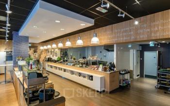 Spacious and modern pantry area at Professor E.M. Meijerslaan 1, Amstelveen, featuring sleek wooden finishes, ample counter space, and contemporary lighting. Perfect for office space rental with a functional yet inviting atmosphere.