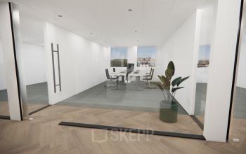 Spacious and modern conference room with glass walls at Professor E.M. Meijerslaan 1, Amstelveen, ideal for office space rental. Features a sleek table and chairs, complemented by natural light and a vibrant plant.