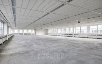 Spacious, unfurnished office to rent at De Gondel 1, Amstelveen, featuring large windows for natural light and an open floor plan ideal for office space rental.