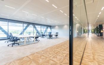 Modern office space at Joan Muyskenweg 137 in Amsterdam Amstel Business Park, showcasing an open floorplan with large windows and sleek furnishings available for office space rental.