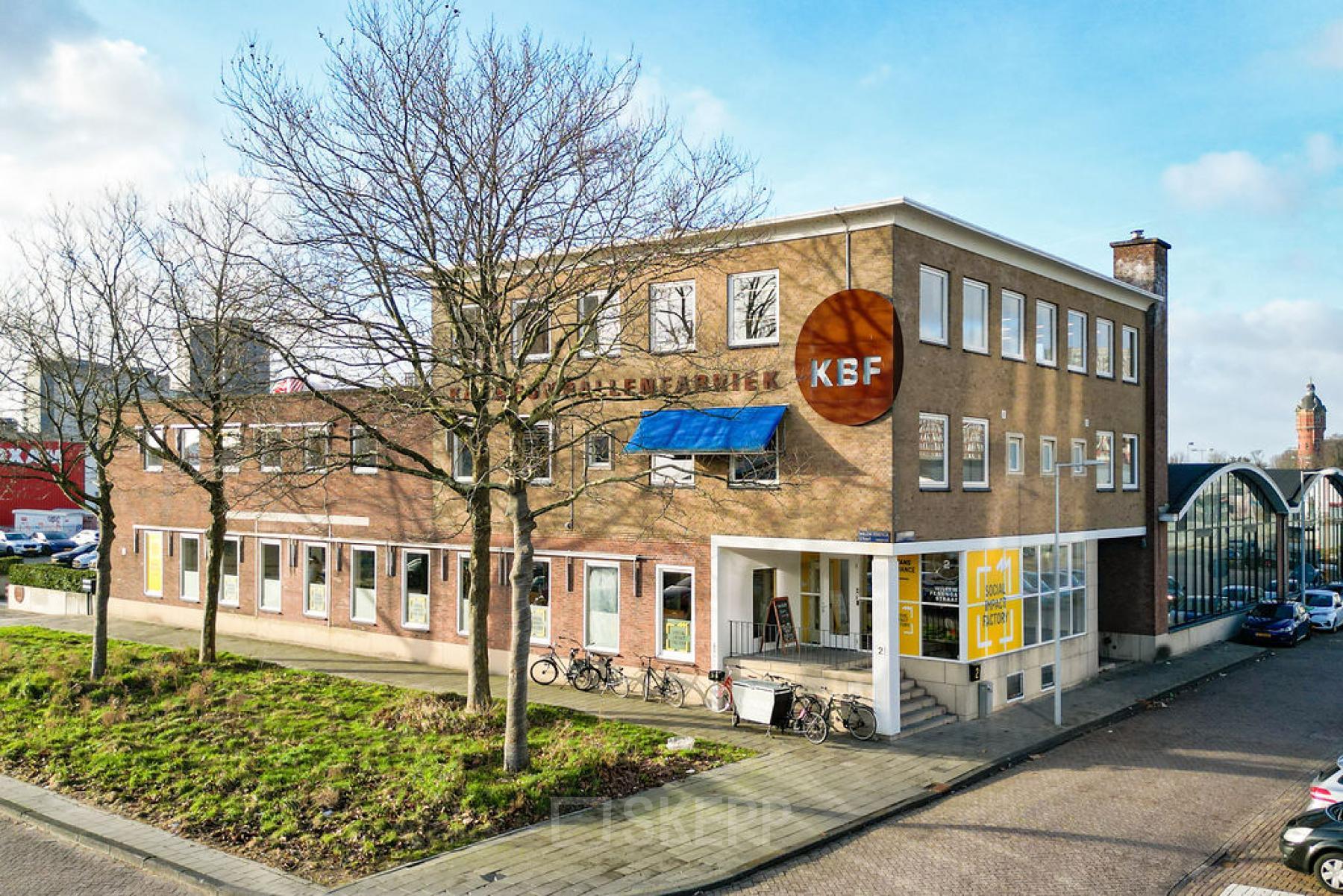 Exterior view of the office building at Willem Fenengastraat 2, Amsterdam Amstel Business Park, with some bicycles parked outside.