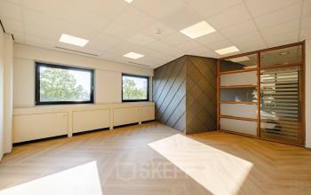 Bright office space with large windows and wooden flooring located at Joan Muyskenweg 82 in Amsterdam Amstel Business Park, ideal for office space rental.