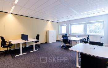 Bright office space with several desks and chairs located at Joop Geesinkweg 901-999, in Amsterdam Amstel Business Park.