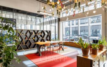 Bright workspace at Joan Muyskenweg 22, Amsterdam Amstel Business Park with modern furniture, plants, and floor-to-ceiling windows.