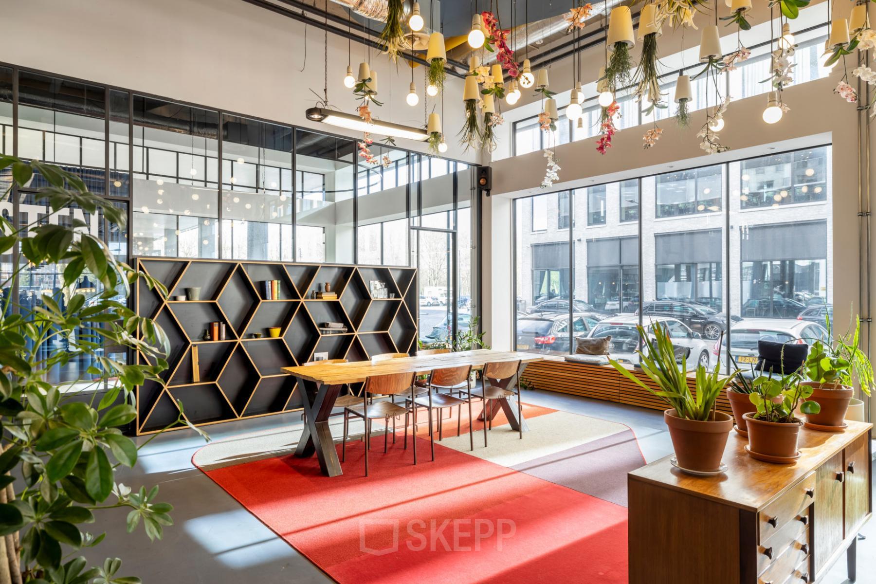 Bright workspace at Joan Muyskenweg 22, Amsterdam Amstel Business Park with modern furniture, plants, and floor-to-ceiling windows.