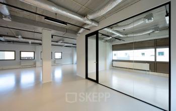 Modern unfurnished office space with glass-walled room located at Joop Geesinkweg 501, Amsterdam Amstel Business Park.