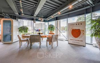 Modern office space with large windows and a meeting area at Prins Bernhardplein 200, ideal for office space rental in Amsterdam Amstel.