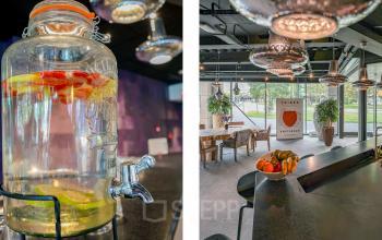 Modern office to rent at Prins Bernhardplein 200, Amsterdam Amstel, featuring a stylish meeting area with a view of the outdoors and a refreshing water station.