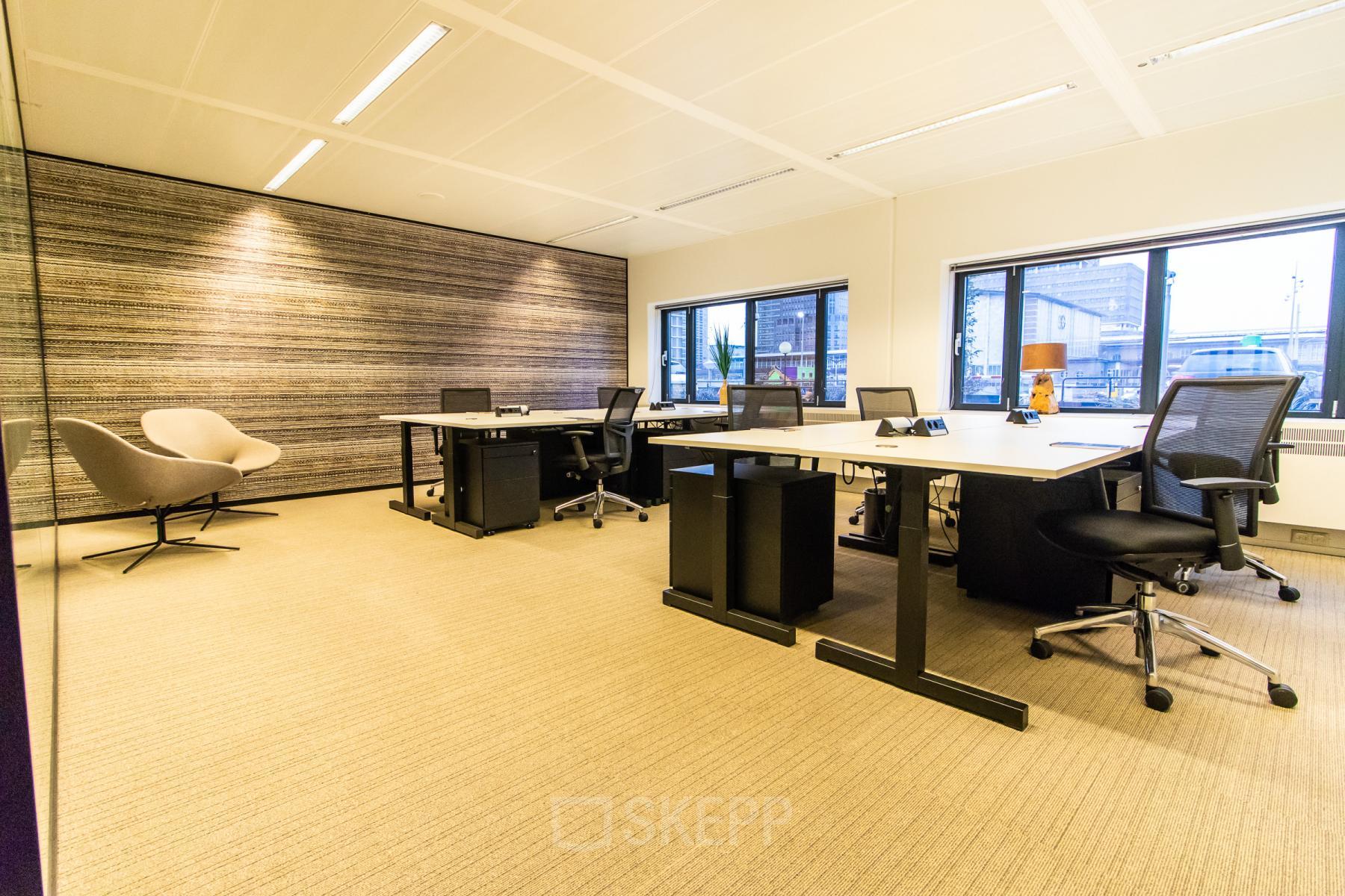 Spacious and well-lit office space available for rent at Prins Bernhardplein 200, Amsterdam Amstel, featuring modern furnishings and multiple workstations.