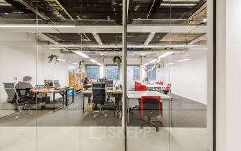 Modern office space rental at Wibautstraat 135, Amsterdam Amstel, showing a bright workspace with employees focused on their tasks.