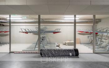 Office space rental available at Walborg 2A in Amsterdam Buitenveldert featuring a storage area with bike racks and visible infrastructure.