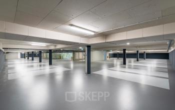 Spacious underground parking area at Walborg 2A in Amsterdam Buitenveldert, suitable for office space rental. The well-lit area is ideal for businesses seeking office space to rent with ample parking.