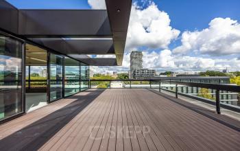 Spacious office terrace at Zwaansvliet 1, Amsterdam Buitenveldert, perfect for breaks or informal meetings, offering panoramic views. Consider this unique office space rental in a vibrant location.