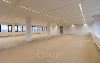 Office space for rent at Buitenveldertselaan 102-120, Amsterdam Buitenveldert, Amsterdam, featuring a spacious and well-lit interior with large windows and modern lighting.