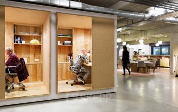 Spacious office space rental at Vijzelstraat 68-78, Amsterdam Center, with modern furnishings and engaged professionals at work.