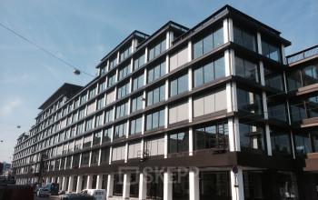 Modern office space rental at Vijzelstraat 68-78 with a sleek glass facade in Amsterdam Center.