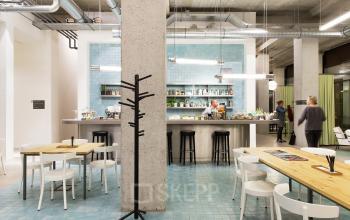 Stylish and inviting office space rental at Vijzelstraat 68-78, Amsterdam Center, with a cozy cafe area and modern industrial design.