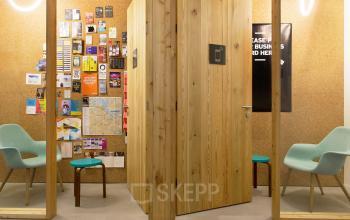 Cozy office space rental at Vijzelstraat 68-78, Amsterdam Center with comfortable seating and a cork board wall for brainstorming.