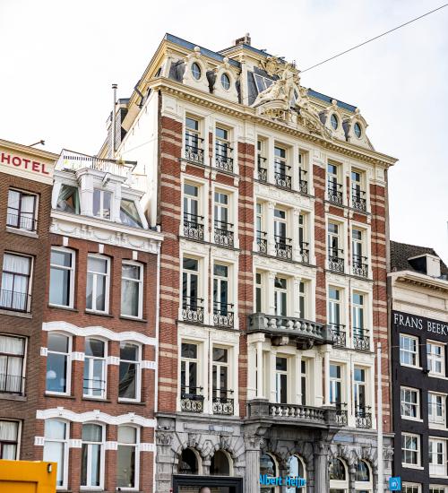 Elegant exterior of office building at Prins Hendrikkade 21, Amsterdam Center, showcasing intricate architectural details perfect for an office space rental.