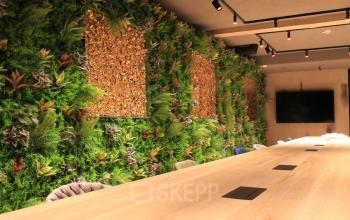 Office to rent at Hekelveld 8-10, Amsterdam Center, features a modern conference room with lush vertical gardens, a large wooden table, and integrated technology for meetings.