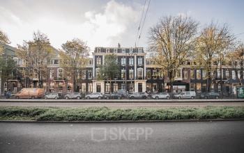 Street view of office buildings at Westeinde 14-16, Amsterdam Center, with multiple cars parked along the sidewalk.