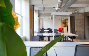 Bright office space at Weesperplein 4b, Amsterdam Center available for rent with modern furnishings, natural light, and open workspaces.