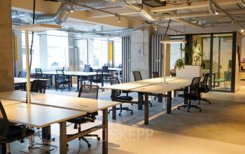 Spacious office to rent at Weesperplein 4b, Amsterdam Center, featuring a modern open floorplan with multiple workspaces and natural light. Ideal for office space rental.