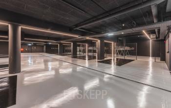 Modern parking facility at Weesperstraat 107-121 in Amsterdam Center, showcasing sleek, polished floors and ample bike racks.