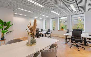 Bright office space rental at Weesperstraat 107-121, Amsterdam Center, featuring modern furnishings, ample natural light, and a clean, professional workspace.