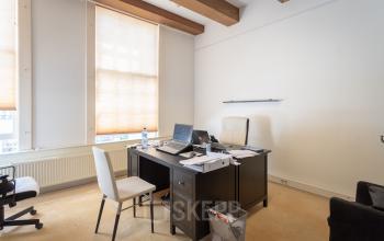 Office space rental at Keizersgracht 241-2, Amsterdam Canal Belt, featuring a neatly organized work desk with bright natural light.