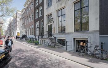 Elegant facade of office space rental at Keizersgracht 241-2, Amsterdam Canal Belt, bathed in natural light with a view of the canal.