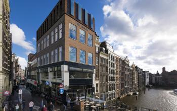 Exterior view of office space rental at Prins Hendrikkade 48 A, Amsterdam Center, highlighting classic architecture with canal views.