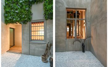 Prins Hendrikkade 48 A features a serene, minimalist entrance with greenery and decorative windows, perfect for a welcoming office environment in Amsterdam Center.