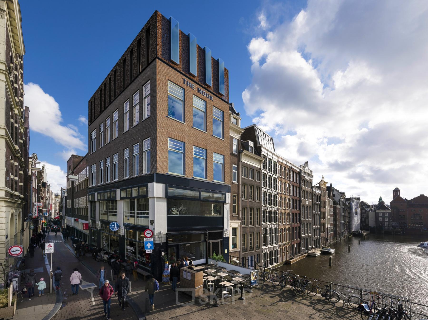 Exterior view of office space rental at Prins Hendrikkade 48 A, Amsterdam Center, highlighting classic architecture with canal views.