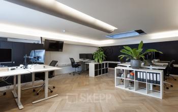 Bright office space at Rokin 46-1, Amsterdam Center, showcasing modern workstations, natural light, and plants, ideal for a productive work environment. Perfect for those seeking office space rental.