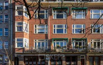 Exterior view of an office building at Groenmarktkade 5-H, Amsterdam Center, ideal for office space rental, showcasing a classic brick facade with large windows.
