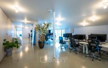 Spacious office at Groenmarktkade 5-H, Amsterdam Center, featuring modern workstations, sleek flooring, and abundant natural light ideal for office space rental.