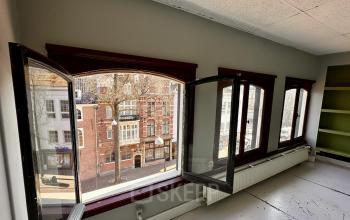 Spacious interior with large open windows providing a street view at Nieuwezijds Voorburgwal 340. Ideal for office space rental with natural light highlighting the potential for a vibrant workspace.