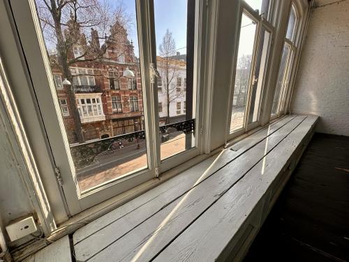 Charming view from the large windows of an office to rent at Nieuwezijds Voorburgwal 340, capturing the vibrant Amsterdam Center streetscape.