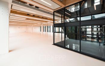 Spacious, modern interior of an office available for rent at Pieter Cornelisz. Hooftstraat 7 7, Amsterdam Center, featuring open floor design and large windows for natural light.