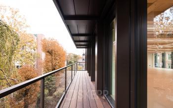 A balcony area overlooking autumn trees in Amsterdam Center, connected to the office space rental at Pieter Cornelisz. Hooftstraat 7 7, offering a tranquil view and exterior access.