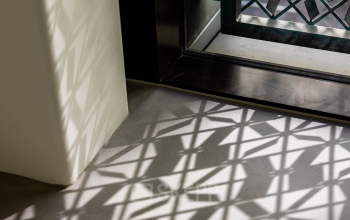 Geometric shadows cast on the floor by a patterned window in an office space rental at Pieter Cornelisz. Hooftstraat 7, Amsterdam Center.