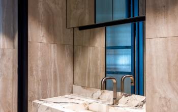 Marble-accented restroom space suitable for office to rent at Pieter Cornelisz Hooftstraat 7, featuring contemporary design elements.