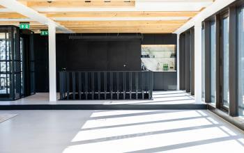 Spacious office with modern black staircase, bright natural light, and minimalist design located at Pieter Cornelisz. Hooftstraat 7 in Amsterdam Center. Ideal for office space rental.