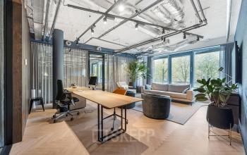 Modern office space with stylish furnishings and large windows at Stadhouderskade 55, ideal for an office to rent in Amsterdam Center.