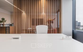 Stylish office space at Piet Heinkade 55, Amsterdam Center with a modern workspace setup and floor-to-ceiling windows, available for office space rental.