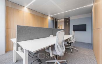 Modern office space for rent at Piet Heinkade 55, Amsterdam Center, featuring sleek furnishings and a neutral palette, ideal for efficient work.