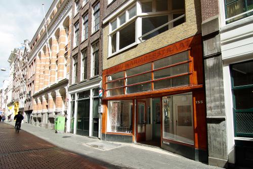 Exterior view of an office building at Warmoesstraat 155, Amsterdam Center, showcasing its traditional brick facade. Ideal for office space rental in a vibrant city location.